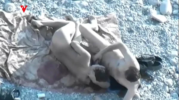 Beach Voyeur. Hot babe with big natural tits gives head on a public beach