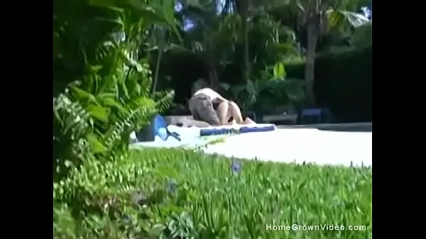 Big tit girlfriend giving a handjob outside by the pool