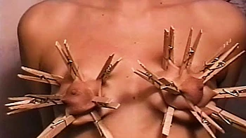 Horny dude loves putting clothes pegs on his slaves tits