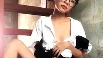 Asian teen plays with toys on webcam