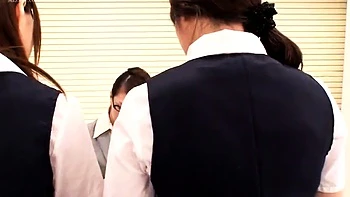 A blonde Japanese babe kisses another lesbian