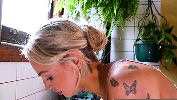 Sexy blonde babe fingers her pink cunt in the bathroom