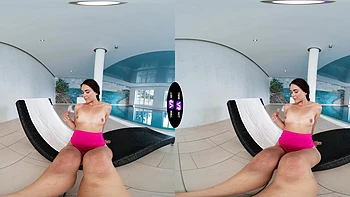 Stunning brunette Vixi Rafi enjoys solo play by the pool.